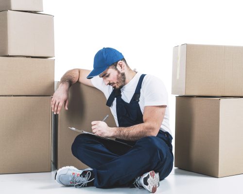 courier-writing-clipboard-near-parcels