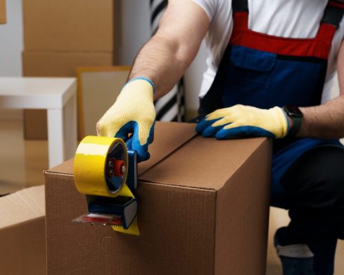 man-mover-in-uniform-packing-boxes-with-scotch-tape.jpg