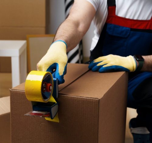 man-mover-in-uniform-packing-boxes-with-scotch-tape.jpg