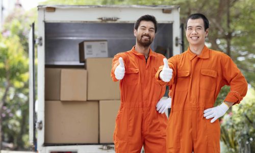 young-delivery-men-showing-ok-sign-near-delivery-car